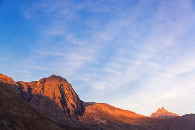 Scenic view of mountains against cloudy sky