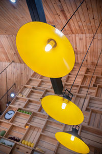 Close-up of yellow balloons on table in illuminated room