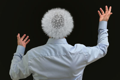 Rear view of man standing against white background