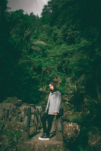 Man standing by trees against plants