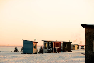 Lifeguard hut against clear sky during sunset