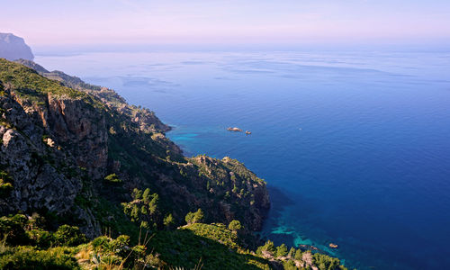 High angle view of sea and mountains against sky