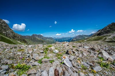 Scenic view of mountains against blue sky