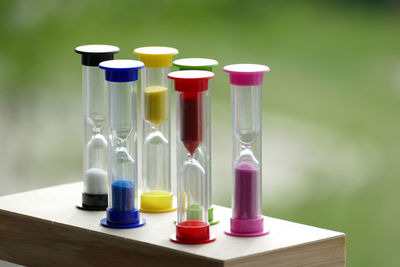 Close-up of multi colored hourglass on table