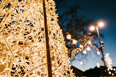 Low angle view of illuminated lights at night