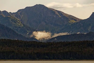 Scenic view of landscape and mountains against sky