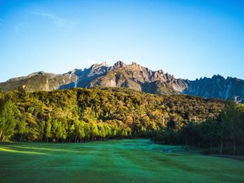 Scenic view of mountains against clear blue sky