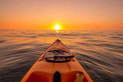 Kayak on sea during sunset