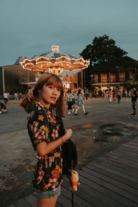 Full length of girl standing against sky in city