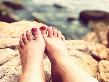 Low section of woman legs on rock