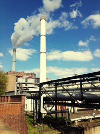 Low angle view of factory against sky