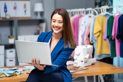 Young woman using laptop at office