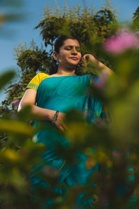 Side view of woman sitting on field
