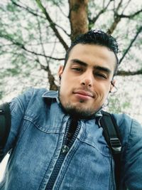 Low angle portrait of young man standing outdoors