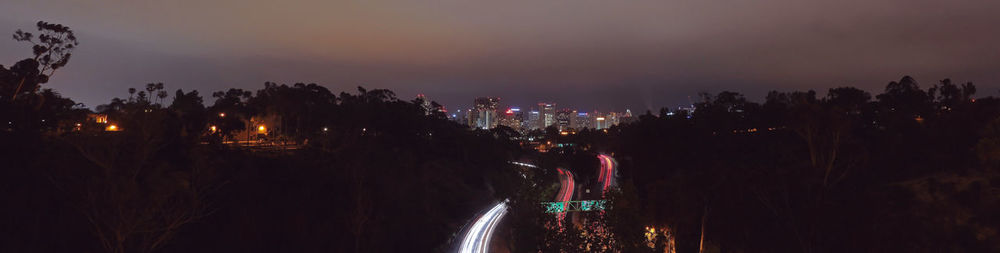 Panoramic view of illuminated city against sky at night