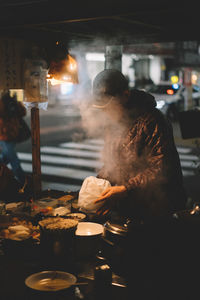 Man working in kitchen at night