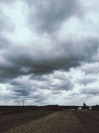 Scenic view of storm clouds over field