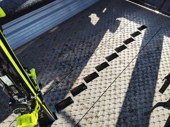 High angle view of shadow on tiled floor