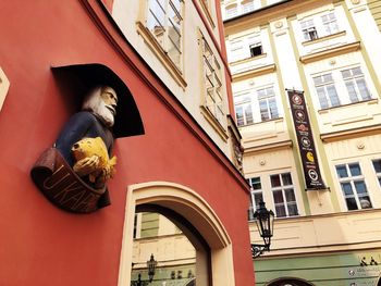 Low angle view of woman standing against building
