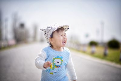 Portrait of cute girl looking away on road