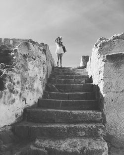 Low angle view of people on stairs against sky