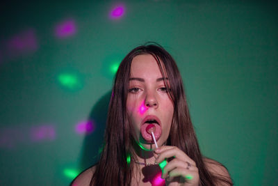 Portrait of beautiful young woman drinking