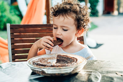 Boy eating food on table