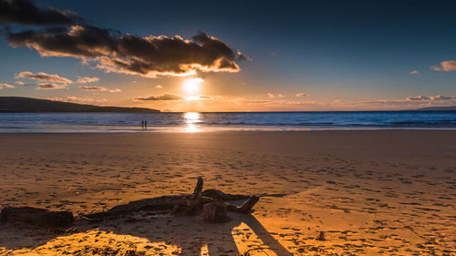 Scenic view of beach against sky during sunset