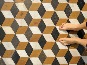 Low section of woman on tiled floor