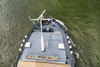 A barge carrying coal with a covered hold on the river rhine. transport of coal and solid fuel.