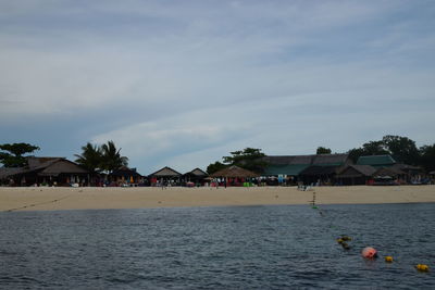 Scenic view of beach by sea against sky