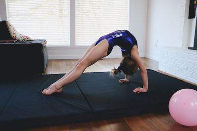 Girl exercising on floor at home