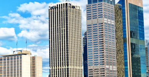 Low angle view of modern buildings in city against sky