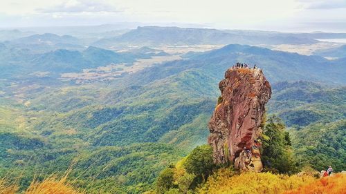 View of tourists climbing mountain on sunny day