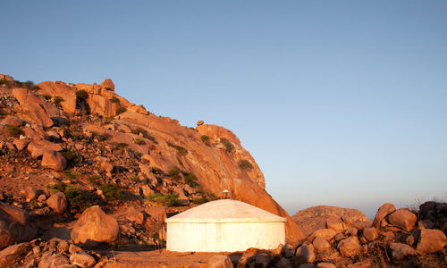 Rock formations on mountain against clear sky