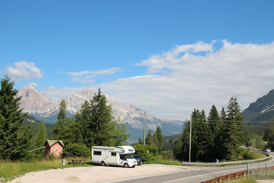 Motor home parked beside road passing through mountains