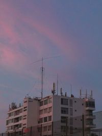 Low angle view of buildings against sky at sunset