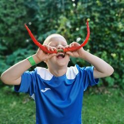 Boy with bell peppers.