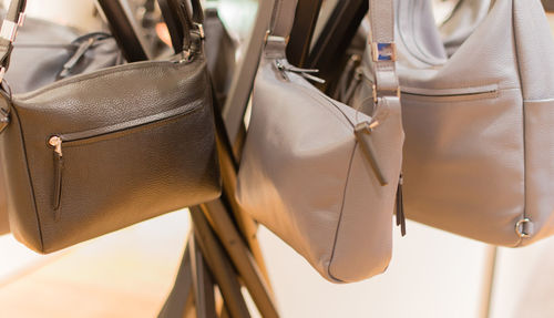 Close-up of bags hanging in market for sale