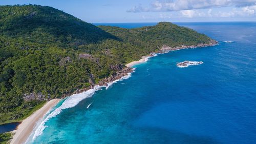 Scenic view of sea and island against sky