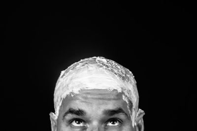 Portrait of man against black background