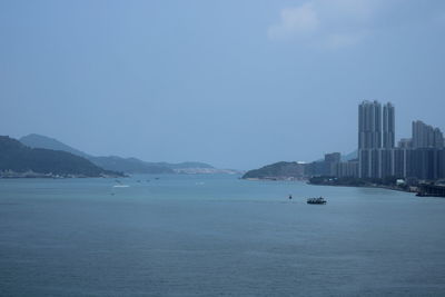 Scenic view of sea against sky in city