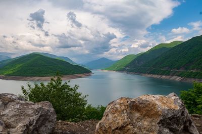 Scenic view of lake and mountains against sky