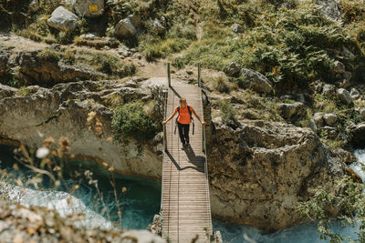 Rear view of woman walking on rock