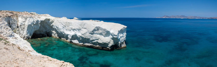 Panoramic view of sea against blue sky