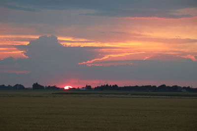 Scenic view of field against sky during sunset