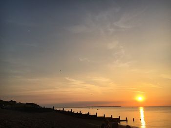 Scenic view of beach against sky during sunset