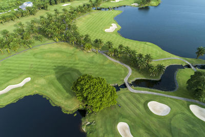 High angle view of golf course by lake