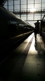 Rear view of woman at railroad station