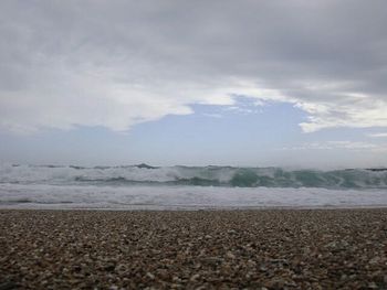 Scenic view of sea against cloudy sky